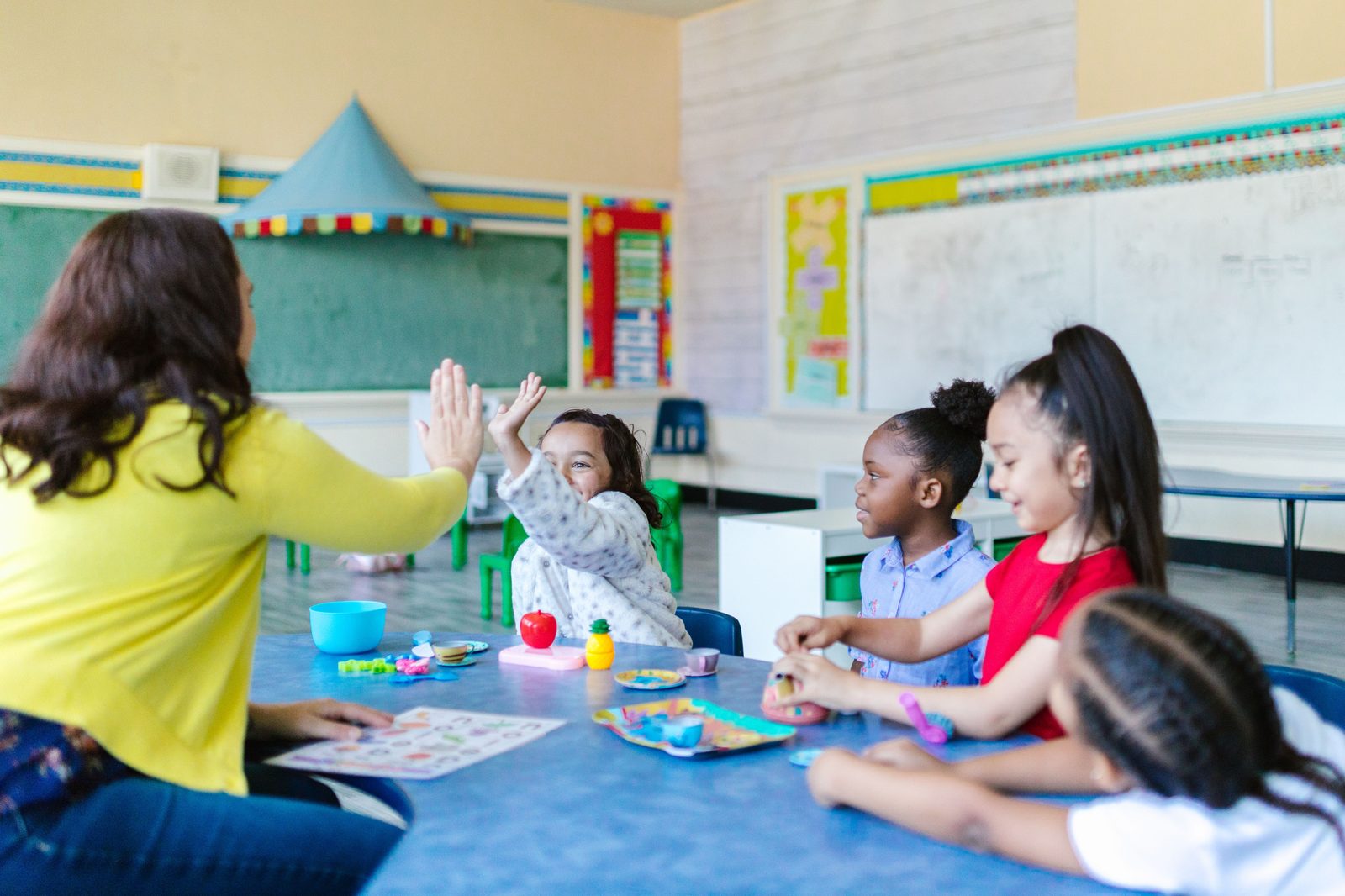 Instructor and students high-fiving in a Future Curriculum classroom